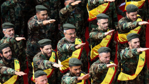 Members of Lebanon's Shiite Hezbollah movement salute behind the coffins of three comrades killed in combat in Syria during their funeral in the southern Lebanese city of Nabatieh on November 8, 2017.  / AFP PHOTO / Mahmoud ZAYYAT        (Photo credit should read MAHMOUD ZAYYAT/AFP/Getty Images)